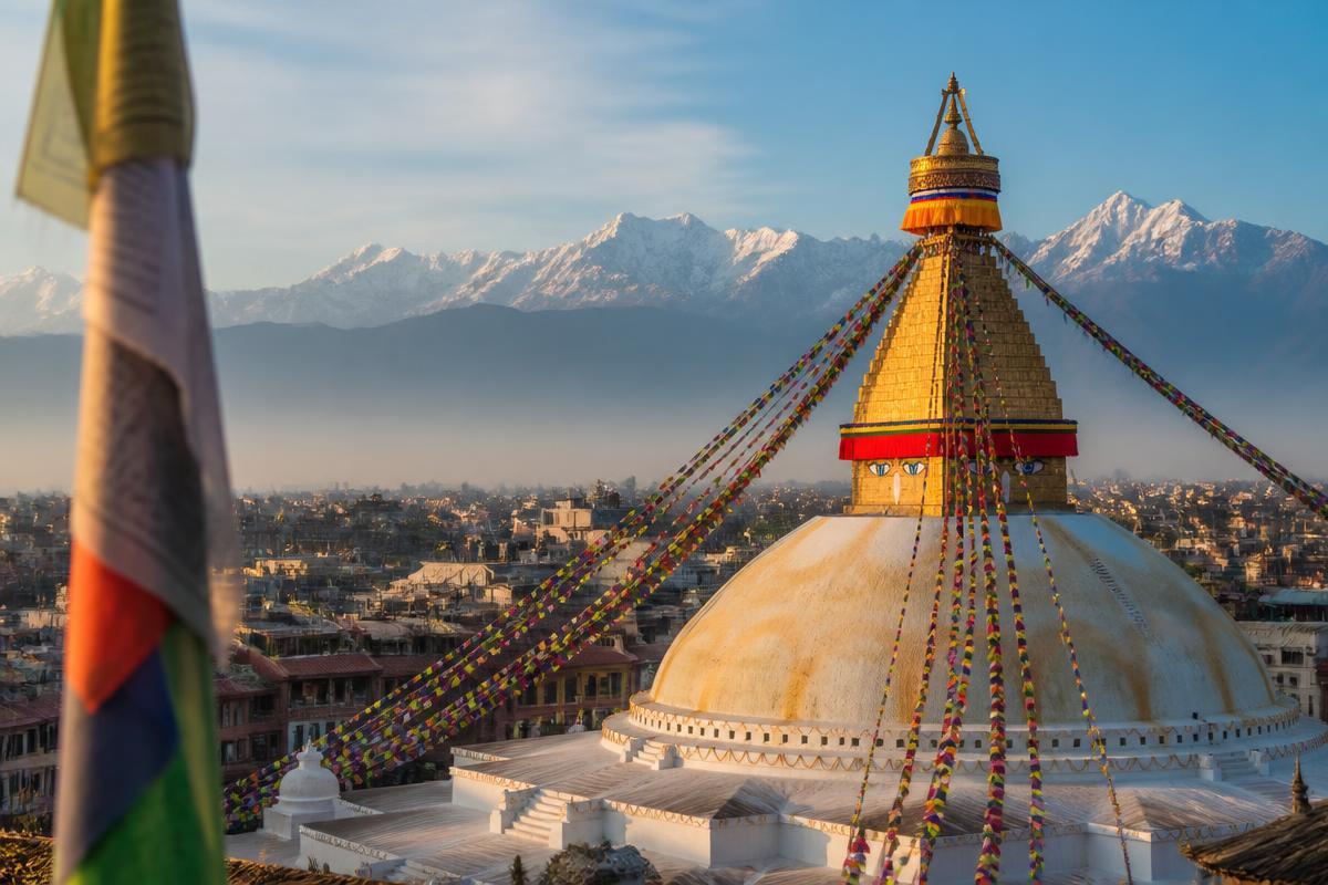 Boudhanath stupa in Kathmandu with Himalayan peaks behind it